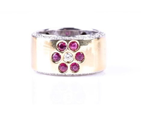 An 18ct white and yellow band ring, inlaid with a diamond ruby floral design, with diamonds to the sides of the band, indisti