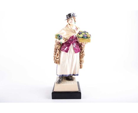 A 1920s Charles Vyse ceramic figure, 'The Shawl', a female flower seller holding a basket in on hand and a posy in the other,