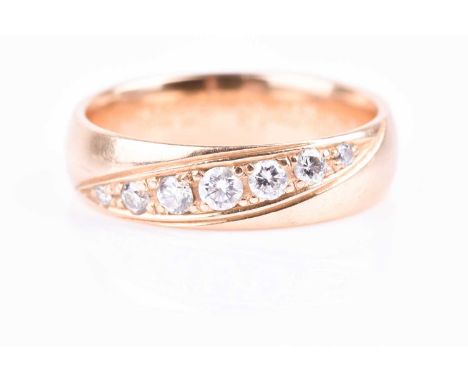 An 18ct yellow gold and diamond wedding band, inset with a graduated row of seven small round-cut diamonds of approximately 0