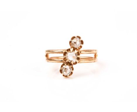 A yellow metal and rose-cut diamond ring, diagonally set with three rose-cut diamonds, each approximately 3 mm diameter, doub