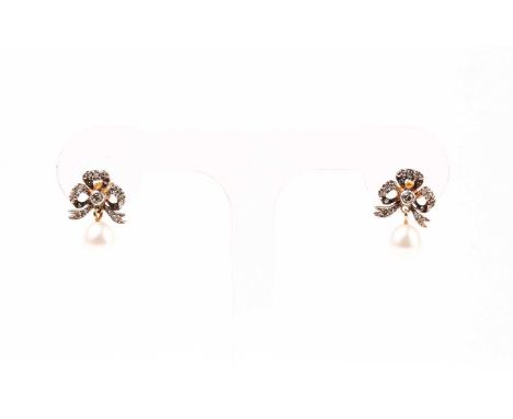 A pair of diamond and pearl drop earrings, the silver set gold-backed bow-shaped mounts inset with round-cut diamonds, each s