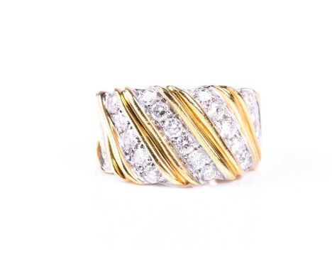 A diamond dress ring, the wide band set with diagonal panels of brilliant cut diamonds, claw-mounted between reeded bands, th