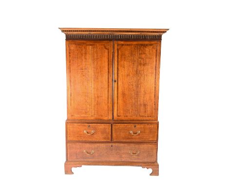 A Geo III oak linen press, the moulded cornice above a frieze of pillar fluting in turn above two cupboard doors with mahogan