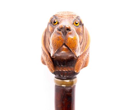 A Black Forest carved wood dog's head walking cane, late 19th century, well defined with inset orange glass eyes, the rear st