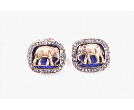 A pair of Russian silver gilt cufflinks, of rectangular form, with a gilt elephant with a diamond set eye, against a blue ena
