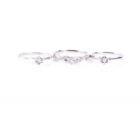 A suite of three diamond rings, comprising two single stone diamond rings and one further diamond ring with diamond set cross