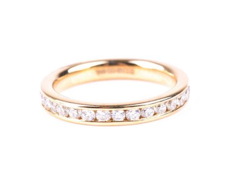 A full hoop diamond eternity ring, the round brilliant cut diamonds channel set in an 18ct gold mount. size N 3.7, estimated 