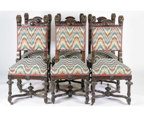 A set of six Victorian dark oak chairs, late 19th century, with carved lion head terminals, with [padded backrests, horsehair