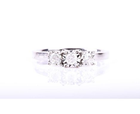 A three stone diamond half hoop diamond ring, the round brilliant cut diamonds in illusion mounts to a 9ct white gold shank, 