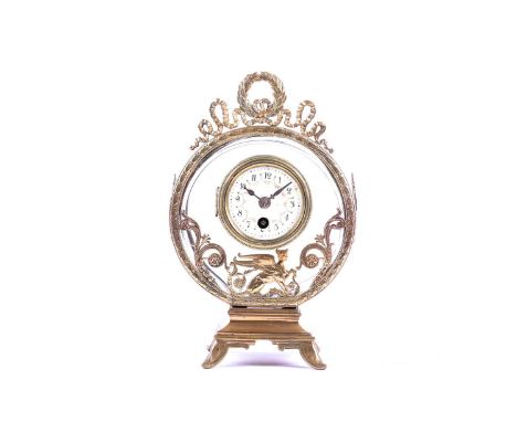 An unusual late 19th century Lenzkirch glass and brass circular mantel clock, the painted enamel dial bearing Arabic numerals
