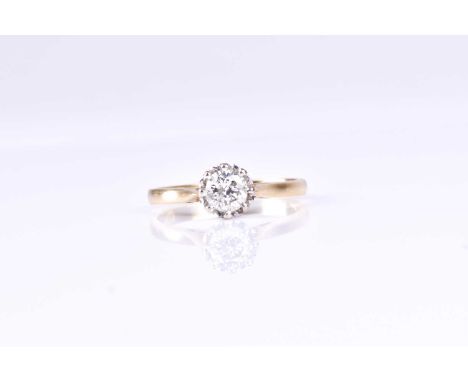 A single stone diamond ring, the round brilliant cut diamond in eight claw raised scalloped mount, to plain 18ct yellow gold 