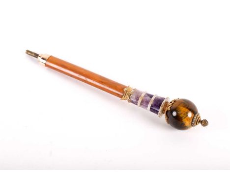 A Russian 14ct gold mounted parasol handle, with pointed finial above a band of diamonds and spherical tigers eye pommel, in 