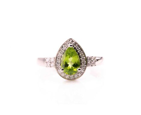 A 14ct white gold, diamond, and peridot ring, set with a pear-cut peridot of approximately 1.15 carats (size engraved to shan