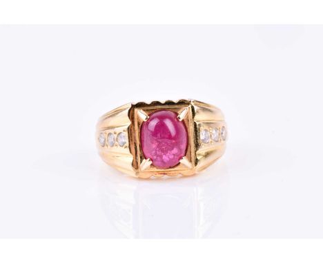 A yellow metal, diamond, and ruby ring, set with a cabochon ruby (treated), four-claw set in a rectangular mount, the shoulde