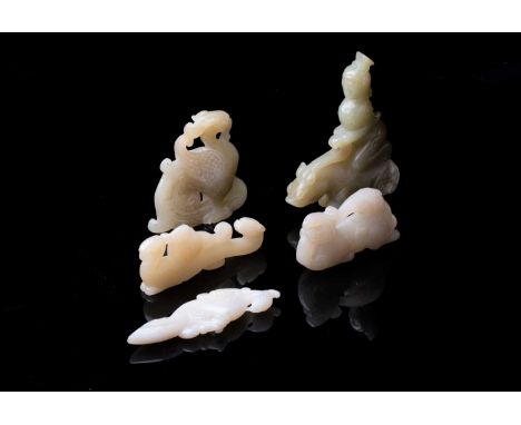 A group of five Chinese jade carvings, to include a belt hook carved as a phoenix with another upon her back, the tail formin