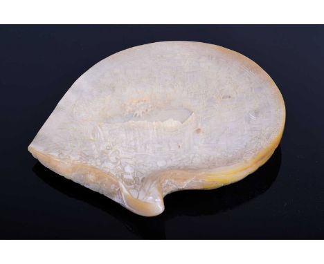 A large Chinese mother of pearl shell, 19th century, finely and intricately carved with numerous figures in varying pursuits 