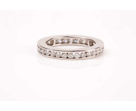 A diamond eternity ring, the white metal band channel-set with round brilliant-cut diamonds of approximately 1.50 carats comb