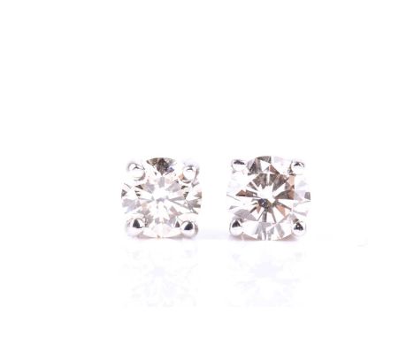 A pair of single stone diamond earrings, the round brilliant cut diamonds in simple four claw mounts, total weight in excess 