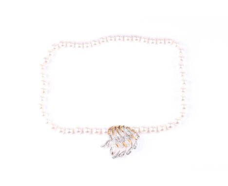 A cultured pearl necklace, the clasp, set to hang at the front, made of unmarked 18ct yellow gold and inset with round brilli