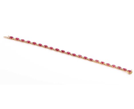 A 14ct yellow gold, diamond, and ruby bracelet, set with twenty-two mixed marquise-cut rubies, the articulated links interspe