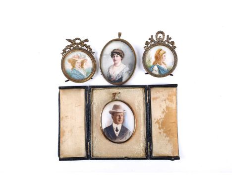 A pair of late 19th century portrait miniatures on ivory, depicting a gentleman and a lady, one in a black leather folding ca