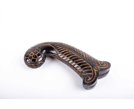 A Mughal style carved jade dagger handle, the terminal carved in relief with a flower, the body with a single leaf to each si