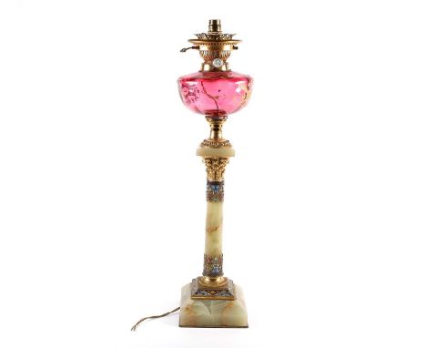 A Victorian onyx and champleve enamel oil lamp, with cranberry glass reservoir etched with a gilt quiver of arrows and flamin