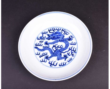 A Chinese blue and white dragon dish, the interior painted with an imperial dragon and sacred pearl amongst clouds within dou