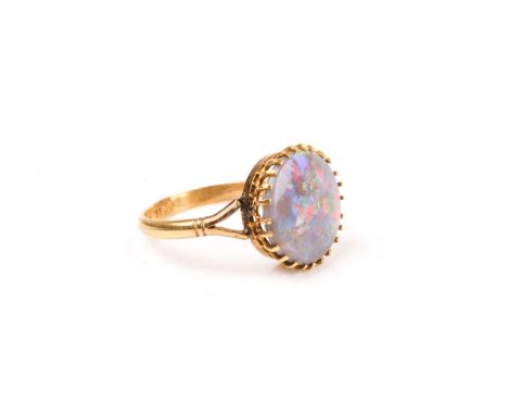 A yellow gold and opal ring, set with a round polished opal (stone a/f), multi-claw set, shank marked 18, size O, in a vintag