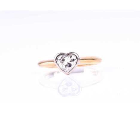 A single stone heart-shaped diamond ring; the heart-shaped brilliant cut diamond in rubover mount to plain 18ct gold shank. D