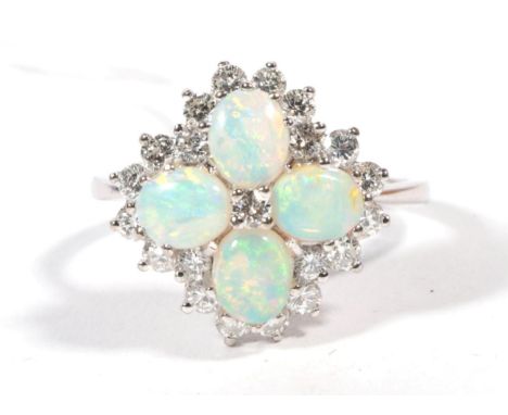 An opal and diamond cluster ring, four oval cut opals with a central round brilliant cut diamond, within a border of round br