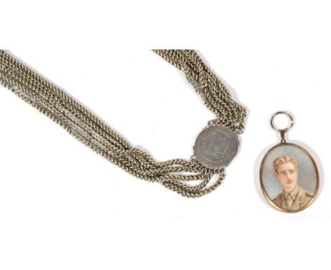 A gilt metal oval pendant depicting a portrait of a lady the verso with a lock of hair; an early 20th century portrait miniat
