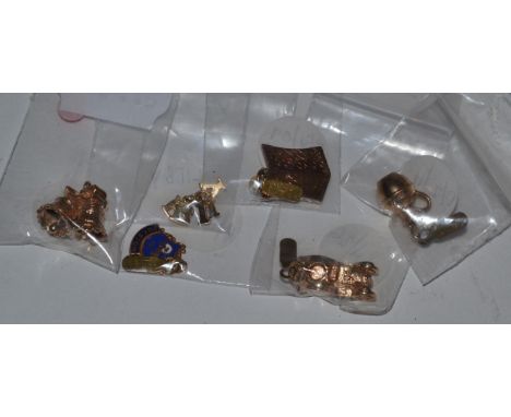 Six various 9 carat gold charms, including; a kettle, a pair of wedding bells, a car, an enamel shield, a 'Libby' charm and a