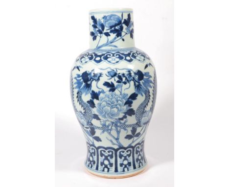 A Chinese blue and white baluster porcelain vase, decorated with a trailing dragon amongst flowering branches, 35.5cm high