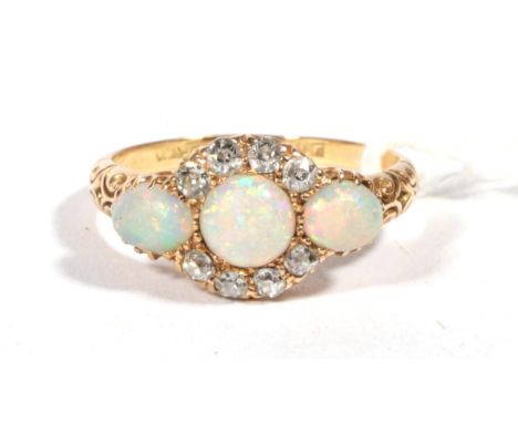 ~ A Victorian opal and diamond cluster Ring, a round opal within a border of old cut diamonds, spaced by oval opals, to carve