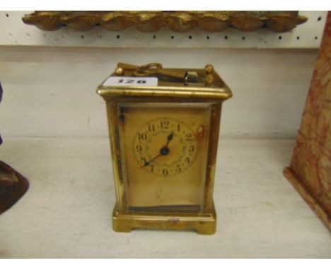 A carriage clock, movement in working order, damage to case