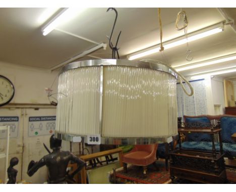 A contemporary glass rod drum shaped crystal chandelier