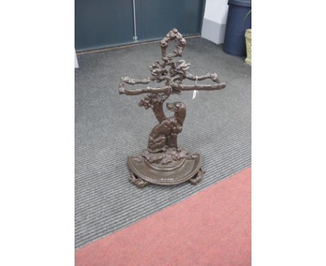 A XIX Century Cast Iron Stick Stand, with naturalistic twin apertures, hunting dog support, over demi lune drip tray, 68cm hi