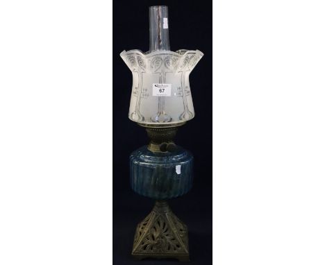 Early 20th Century brass double burner oil lamp with glass reservoir and cast metal base, frosted glass shade with clear chim