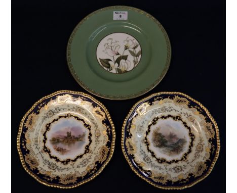 Pair of Coalport bone china cabinet plates, overall with foliate gilding around reserve panels depicting castles in landscape