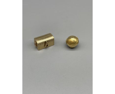 Cartier 14k gold miniature trunk, and gold globe charm.Cartier marked to the base 17mm x 15mm x 14mm, 11.3 grams, globe weigh