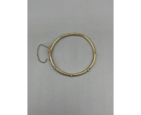 14k Diamond set bangle,set with three 0.05 ct diamonds, dents to bracelet, and safety chain snapped. clasp secure, weight 4.5