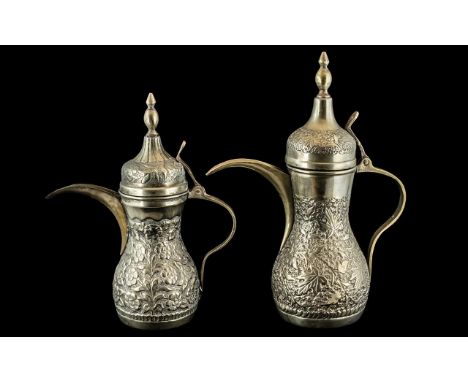 Two Middle Eastern Embossed Coffee Pots, With Finial Lids, 12 &amp; 10 Inches. Stamped to Base G. Silver. 