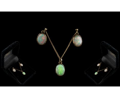 A 9ct Gold Mounted Opal Pendant and Earring Set plain rub over setting with matching plain drop earrings. 