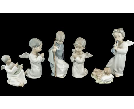 Collection of Five Lladro Figures, comprising three winged angels, one 7'' tall playing a flute, and two kneeling and praying