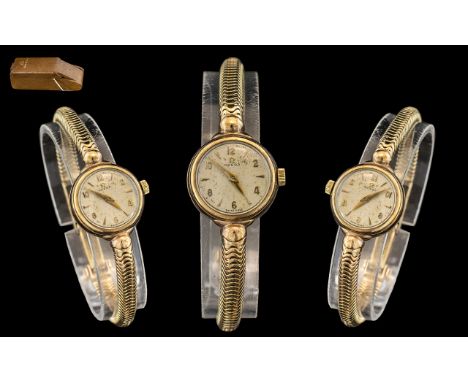 A Ladies 9ct Gold Omega Wrist Watch, champagne dial with baton and Arabic numerals.  Manual wind.  Gross weight 20 grams.  Co