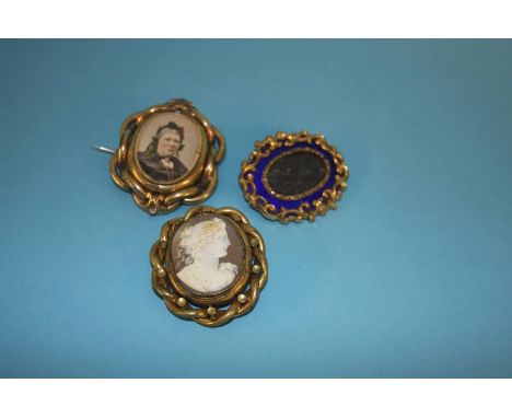 A Victorian mourning brooch, mounted in blue enamel, a swivel mourning brooch and a cameo brooch (3)