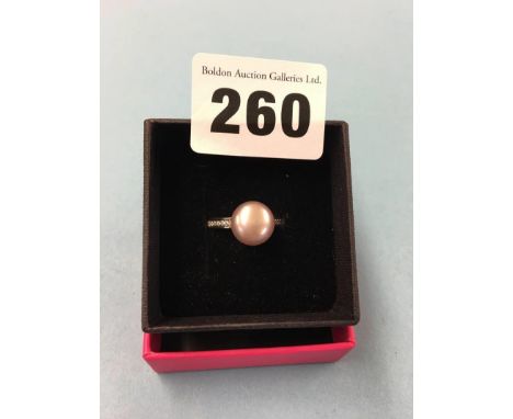 An 18ct white gold ring, mounted with diamonds and a small pearl, size 'N', 5.5 grams