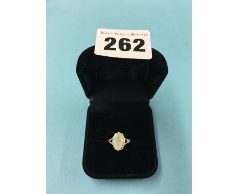 A 9ct rose gold ring, the central opal surrounded by diamonds, size 'N', 2.5 grams