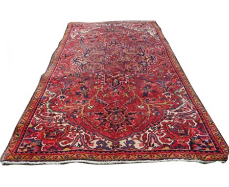 An Ahar Carpet of floral design with a medallion centre in blue, red, beige, etc.  10' 9" (325cms) x 6' (183cms)